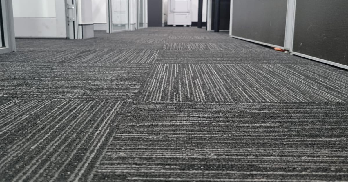 Clean office corridor maintained through a regular office cleaning schedule.
