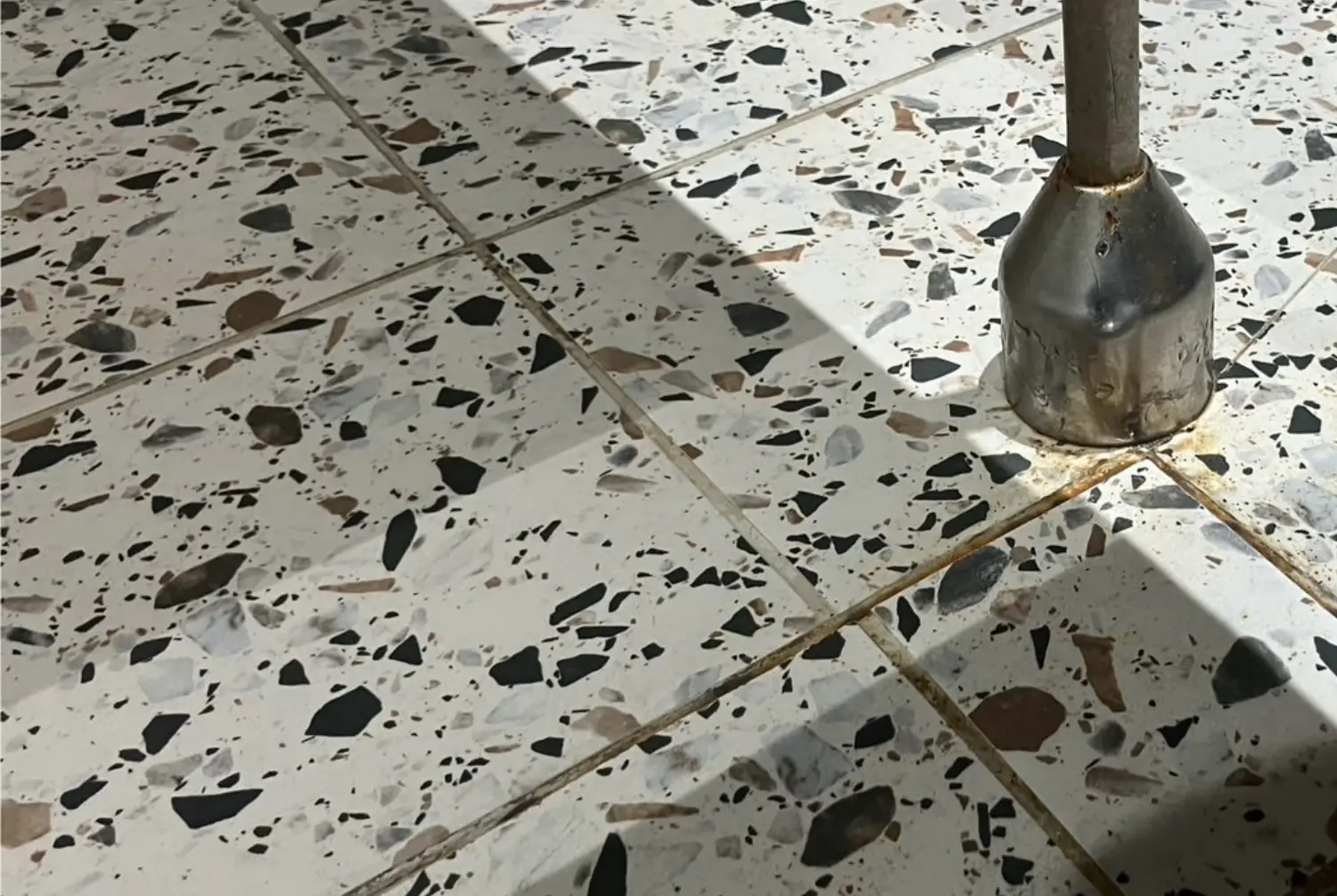 Terrazzo floor and tiled area after commercial cleaning