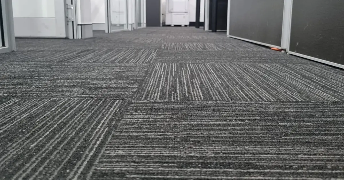Commercial office carpet being maintained as part of workplace cleaning